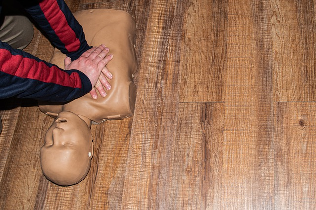 A medical professional practicing CPR on a dummy doll