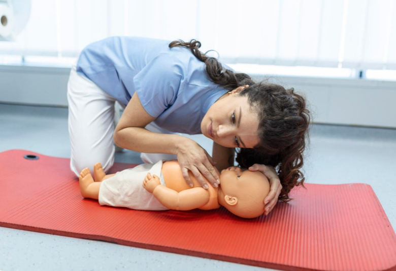 woman practicing infant CPR to maintain life-saving skills