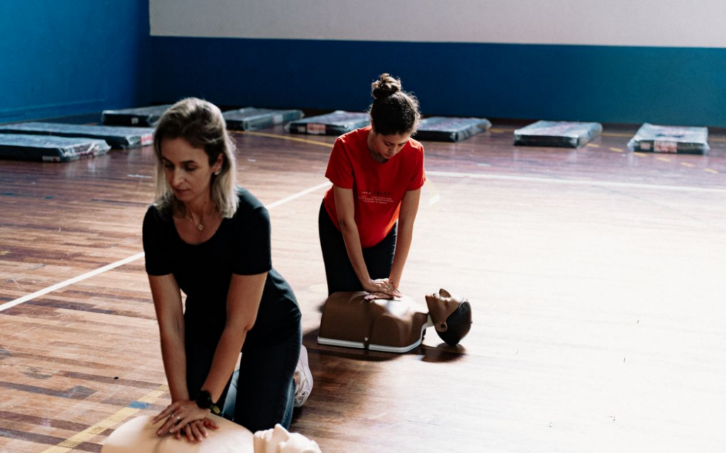 Students practicing CPR & AED training on CPR manikins during a hands-on certification course.