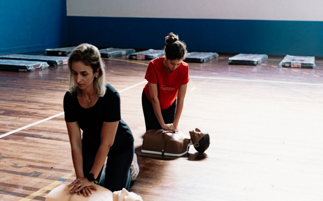 Students practicing CPR & AED training on CPR manikins during a hands-on certification course.