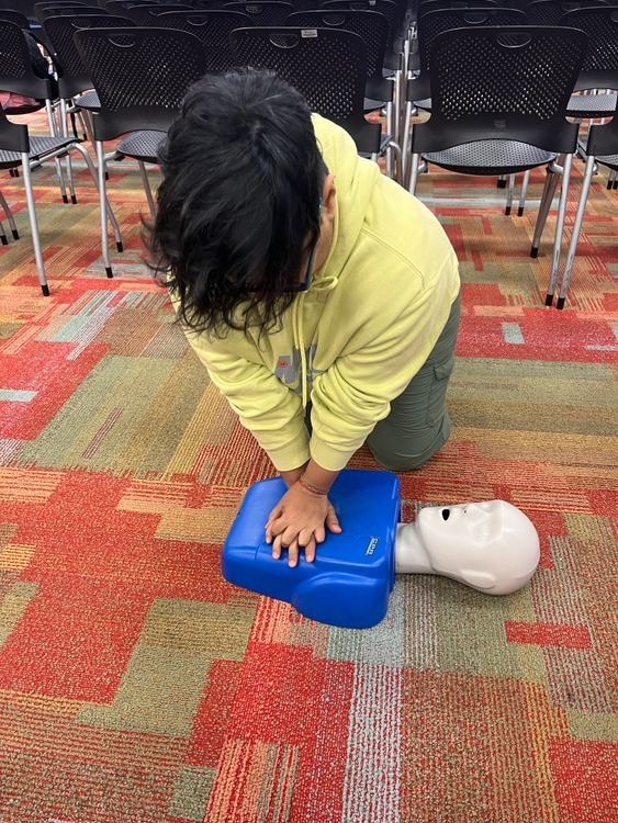 Instructor demonstrating CPR & AED training during a certification course.