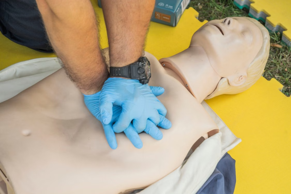 Close-up of a person performing CPR on a dummy